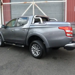 Mitsubishi Triton with EGR Hard Lid – 1 Piece and sports bars, shown in side-rear view.