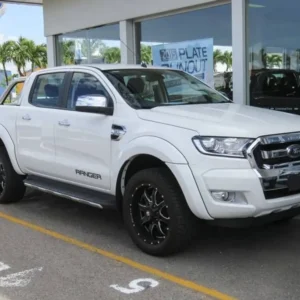 White Ford Ranger Flares pickup truck with black alloy wheels parked outside a dealership.
