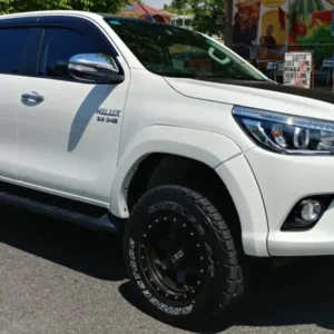 White Toyota Hilux with EGR fender flares and off-road wheels