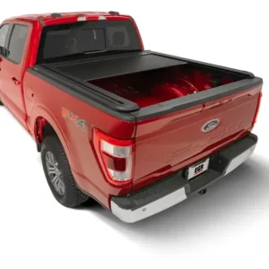 Red Ford F-150 with EGR RollTrac electric tonneau cover half-open over truck bed