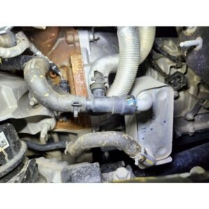 Factory transmission cooler lines and hoses on a diesel 4x4 engine before upgrade installation.