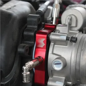 Close-up of Snow Performance red throttle body spacer with water-methanol injection port installed on HEMI engine
