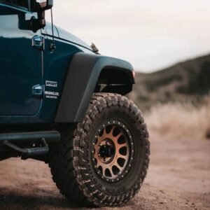 Method Race Wheels 305 NV bronze alloy wheel fitted to Jeep Wrangler on off-road terrain