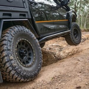 4x4 vehicle off-road on rocky trail fitted with Method Race Wheels 305 NV matte black wheels and all-terrain tyres
