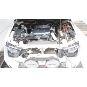 Complete Intercooler Kit with Piping and Installation Hardware Mitsubishi Triton engine bay with aftermarket front-mount intercooler and upgraded piping