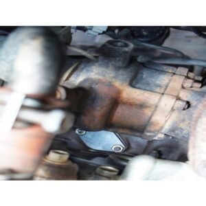 Close-up of turbocharger mounting area with block-off plate on diesel engine