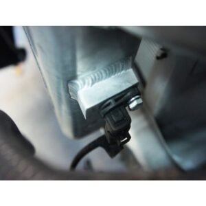 Close-up of intercooler mounting bracket and sensor connection on a turbo diesel vehicle.