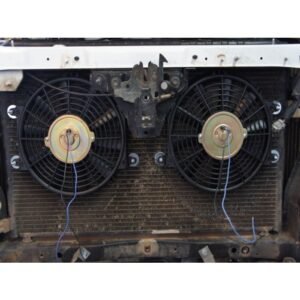 Dual electric radiator cooling fans mounted on vehicle condenser for improved airflow.
