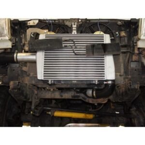 Front-mounted intercooler installed with dual electric fans for enhanced turbocharged engine cooling.