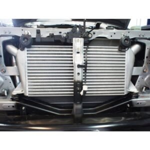 Front mount intercooler installed behind vehicle bumper