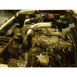 Toyota Landcruiser 80 Series 1HZ engine bay with HPD front mount intercooler piping and hoses installed.