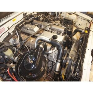 HPD Series 2 Toyota Landcruiser 80 Series Front Mount Intercooler Kit Toyota Landcruiser 80 Series engine bay with HPD front mount intercooler piping installed.