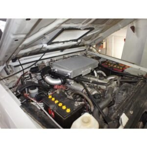 Nissan Patrol engine bay with top-mount intercooler installed under bonnet scoop.