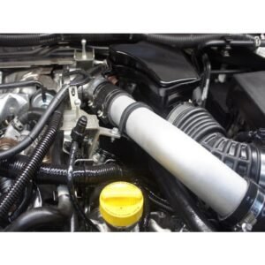 Close-up of intercooler piping connected to intake system in Nissan V6 engine bay