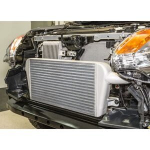 HPD performance intercooler installed on vehicle front end with bumper removed.