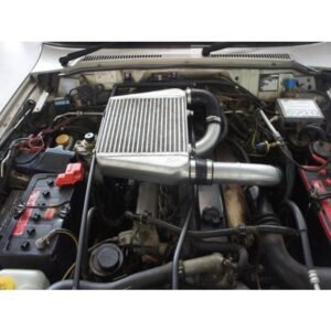 Nissan Patrol engine bay with performance top-mount intercooler and alloy piping installed.