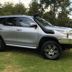 Toyota Fortuner with Safari snorkel and off-road accessories on grass