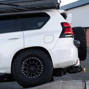 Method Race Wheels 315 Matte Black on white 4x4 SUV with off-road setup and roof rack