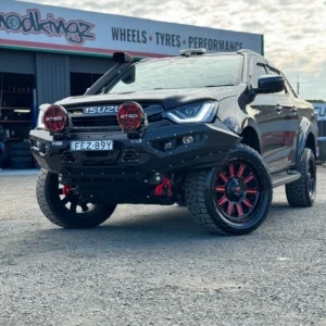 Spartan Bull Bar installed on Isuzu D-Max 2021–2023 parked at workshop with STEDI lights and red alloy wheels