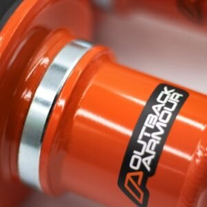Close-up of an orange Outback Armour suspension component with logo and metal collar.
